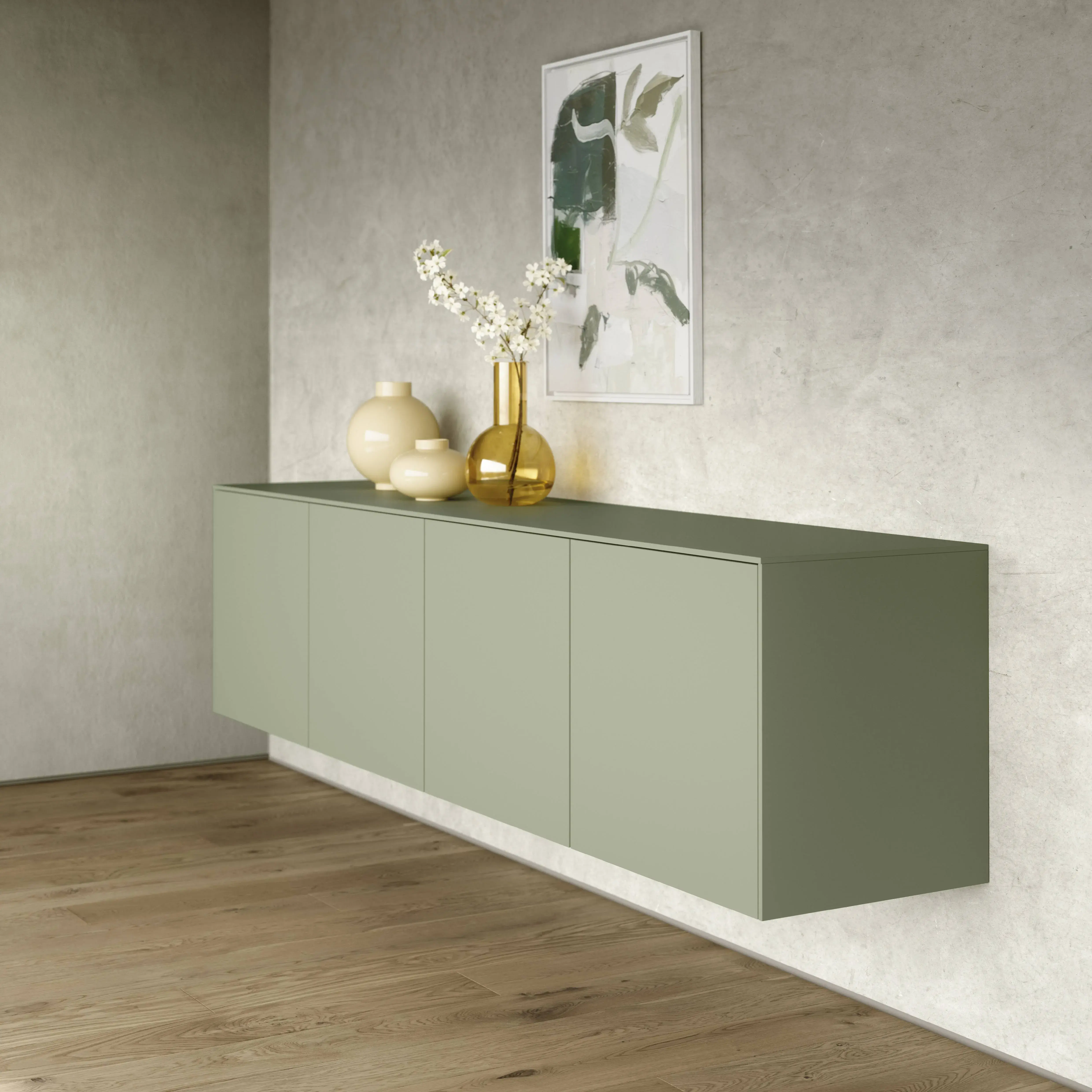 Schwebendes Sideboard in Salbeigrün mit grifflosen Fronten und dekorativen Vasen vor heller Wand